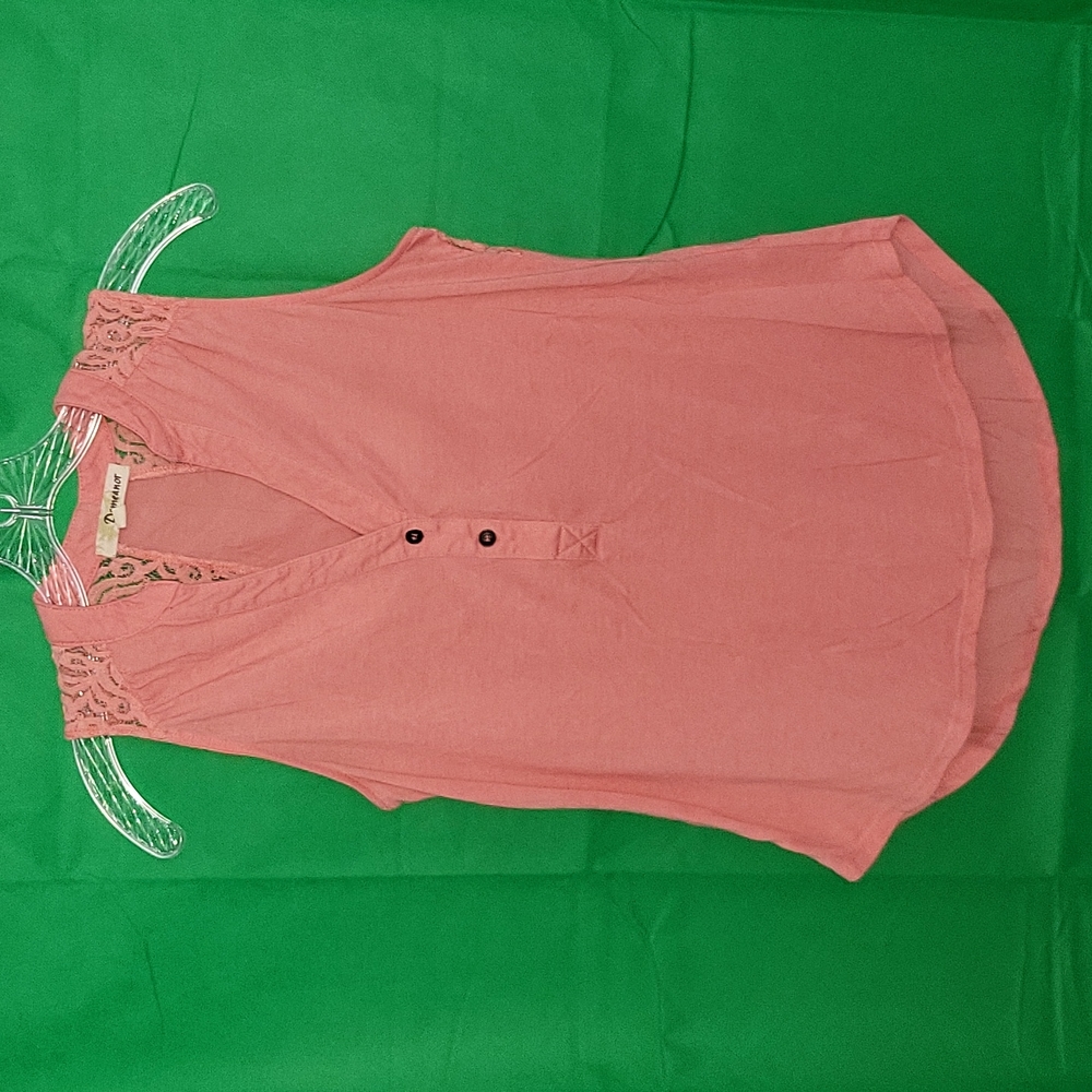 Peach colored sleeveless top